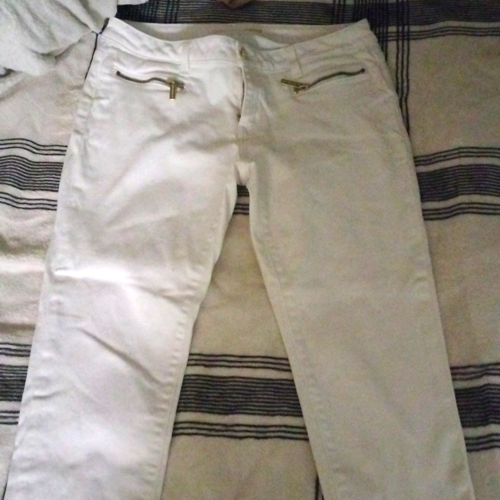 White jeans with gold zippers in the front